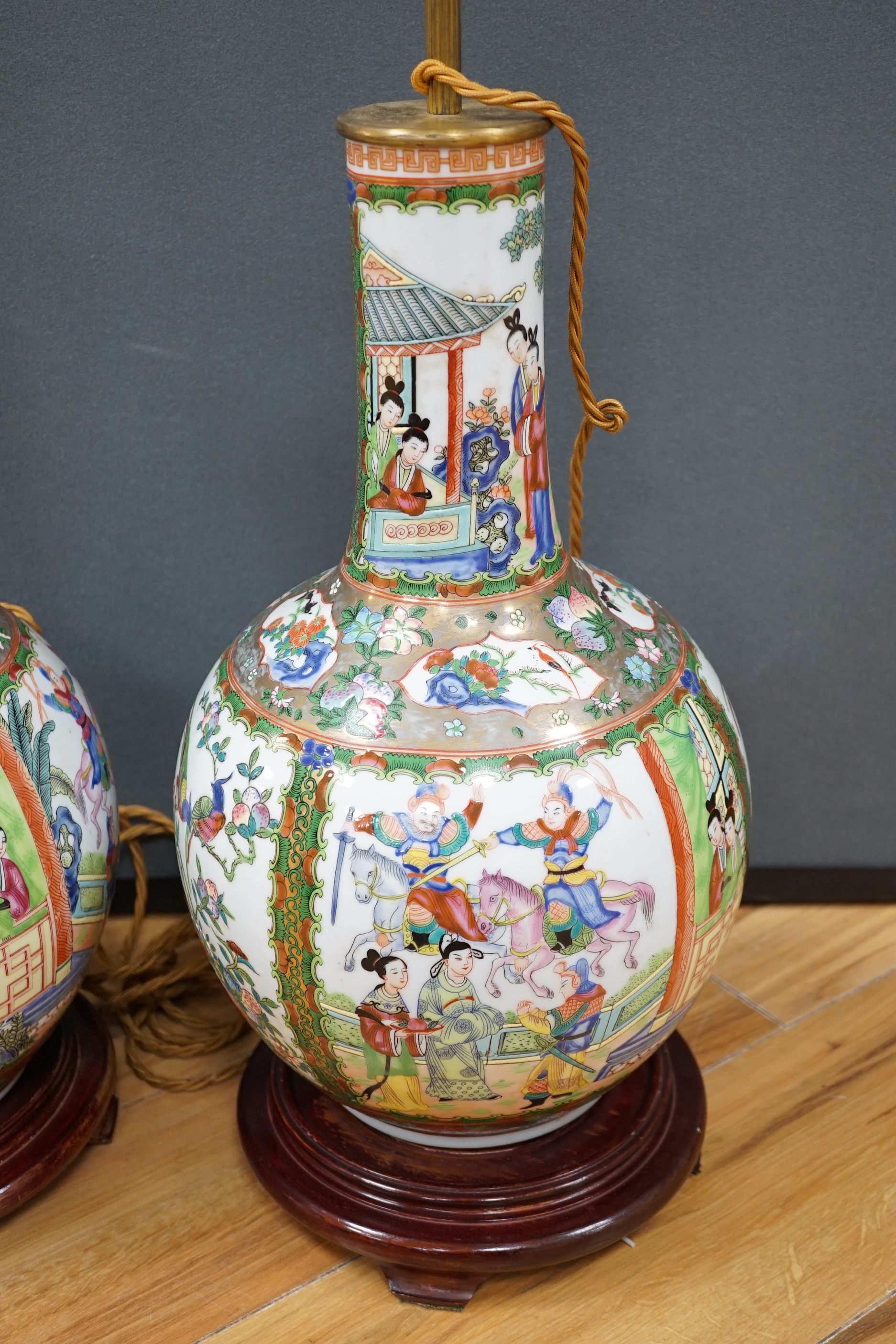 A pair of Chinese famille rose lamp bases on wooden stands, 50cm high